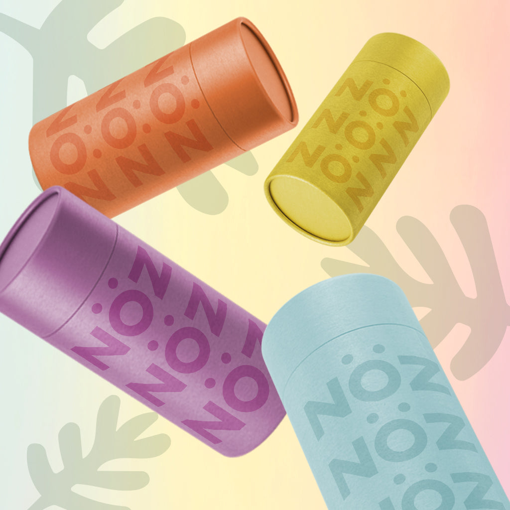 Blue, yellow, orange, and purple colors of Noz’s sunscreen sticks floating